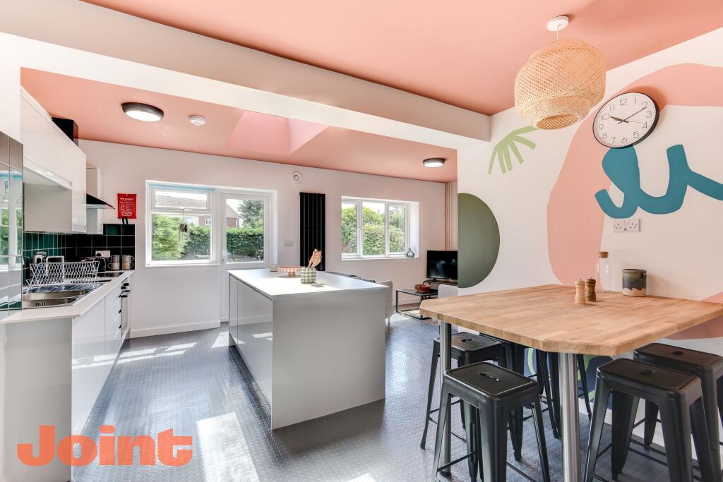 A vibrant and modern kitchen featuring a spacio...
