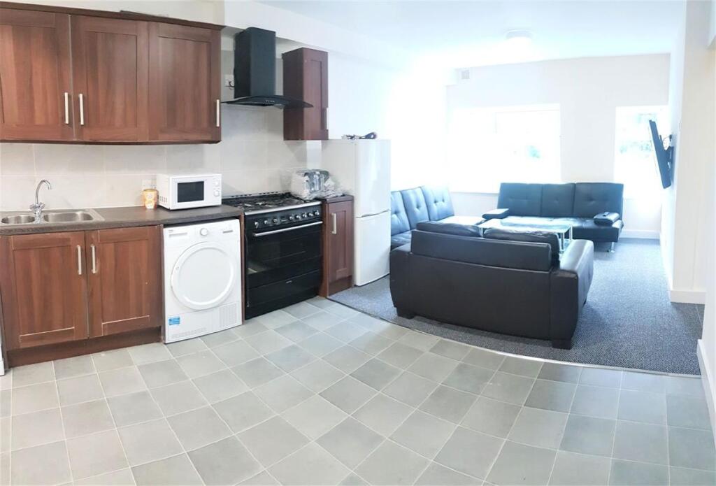 Open-plan kitchen and living area with fitted w...