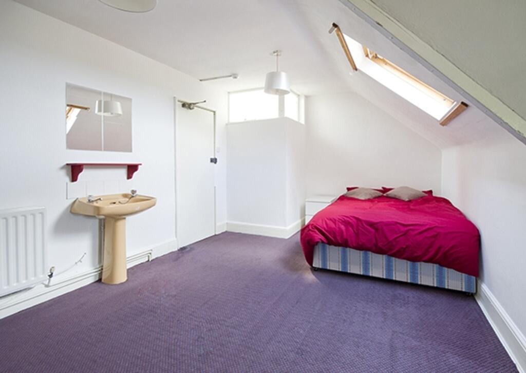A spacious and inviting double bedroom with goo...