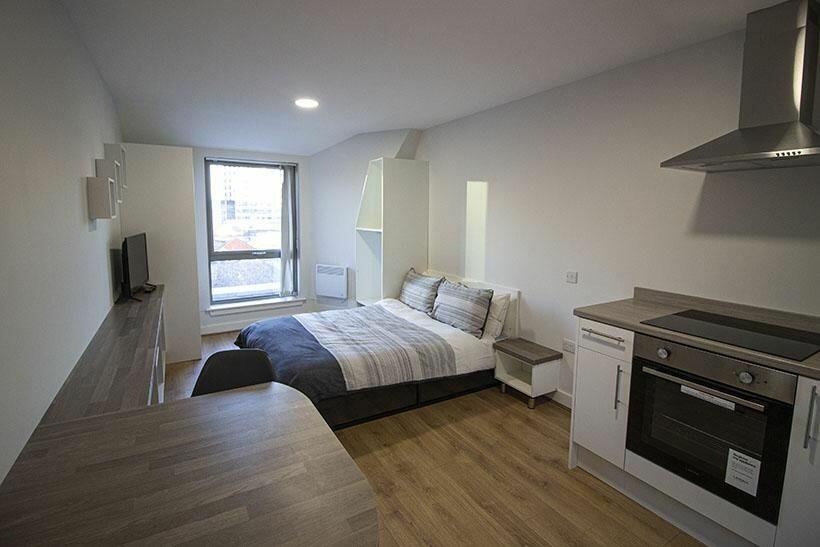 Bright and modern master bedroom featuring a co...