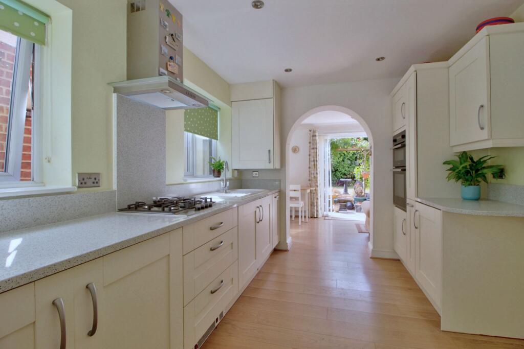 Shaker kitchen leads to sunny breakfast room