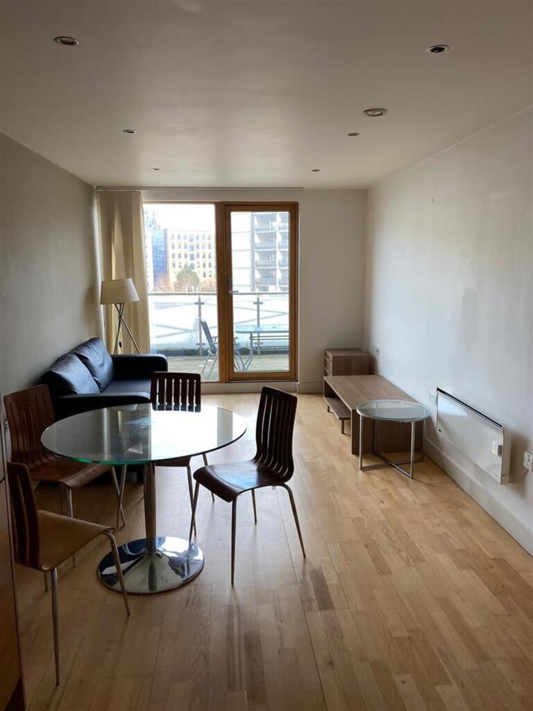 A minimalist living room with wooden flooring, ...