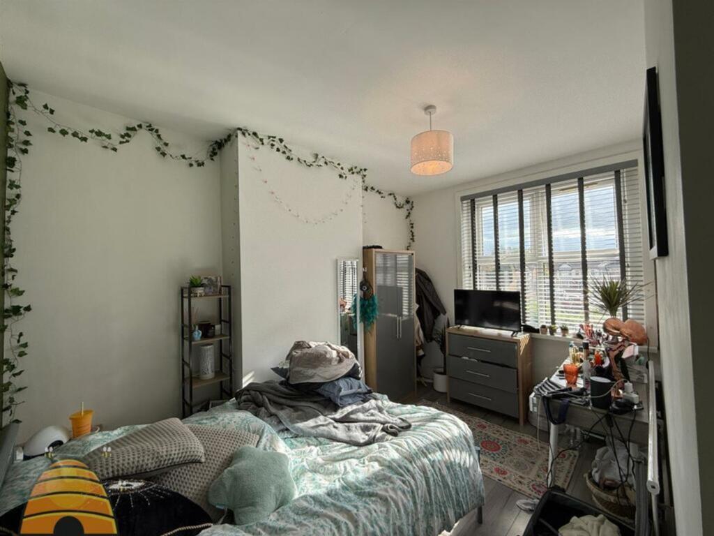 A bright and inviting double bedroom with ample...