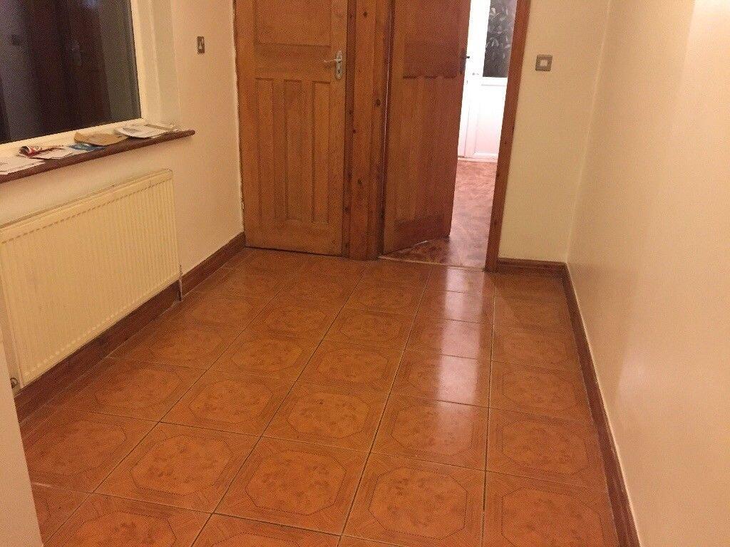Bright, clean hallway with tiled flooring, timb...