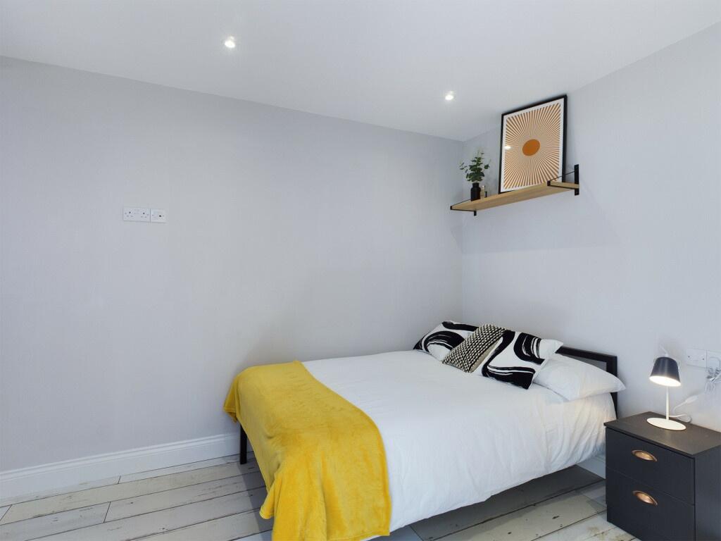 A bright and inviting master bedroom featuring ...
