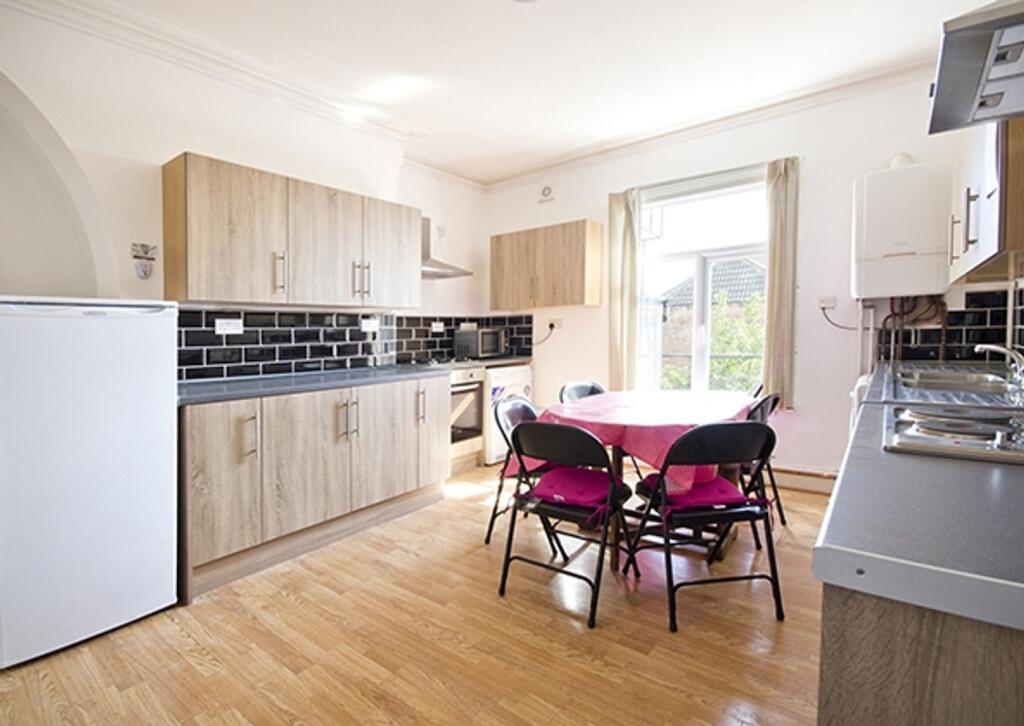 A spacious and inviting kitchen with ample natu...