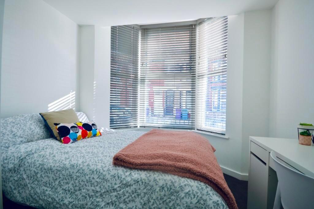 A bright and inviting double bedroom featuring ...