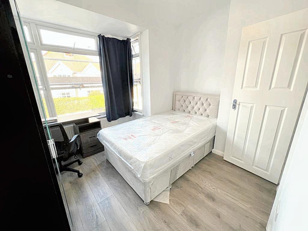 Spacious double bedroom featuring large windows...