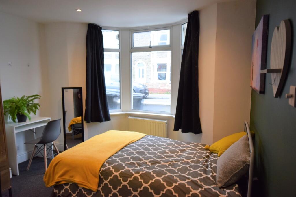 A bright and inviting double bedroom featuring ...