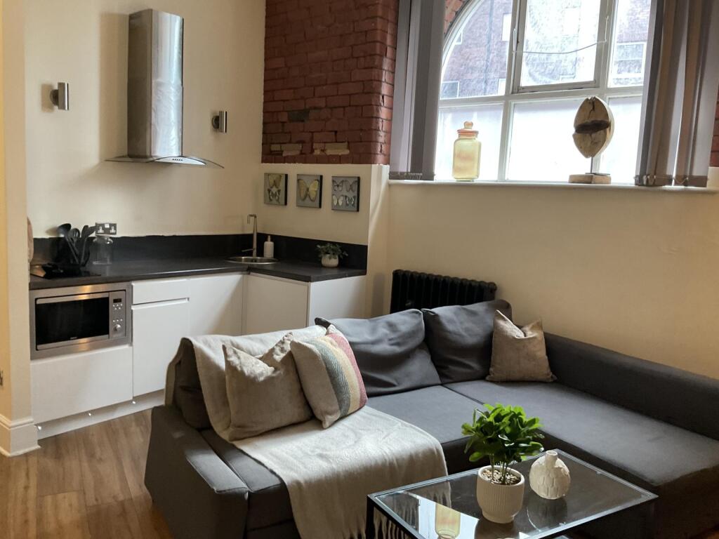 A cozy and modern living room featuring a comfo...