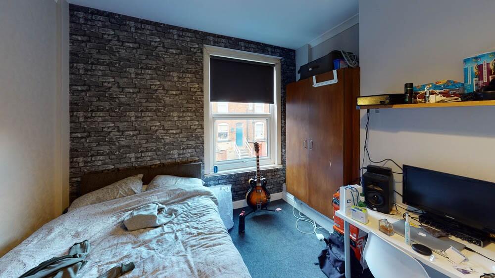 Cozy single bedroom featuring a comfortable bed...