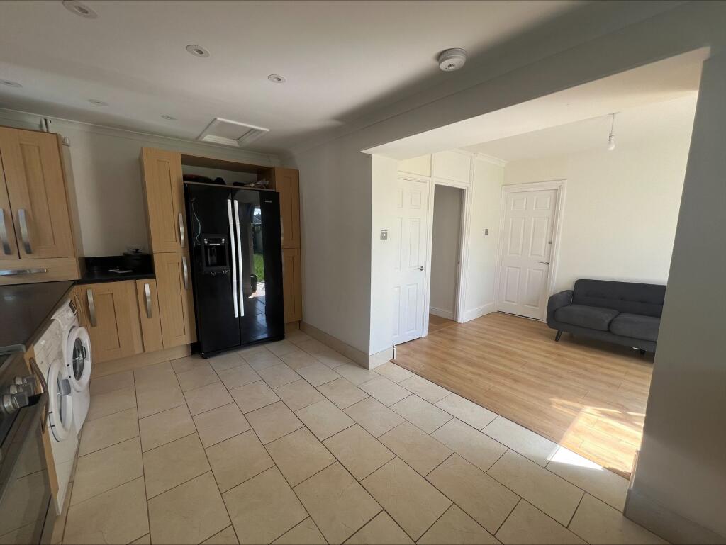 Bright and tidy kitchen area with modern wooden...