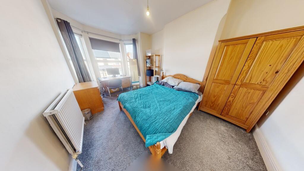Bright and cozy double bedroom featuring a comf...