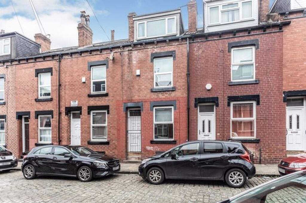 A well-maintained terraced brick house with lar...