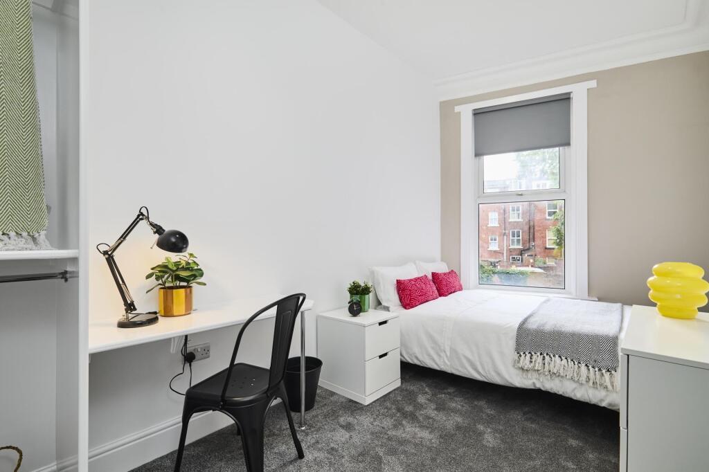 A bright and tidy student bedroom featuring a s...