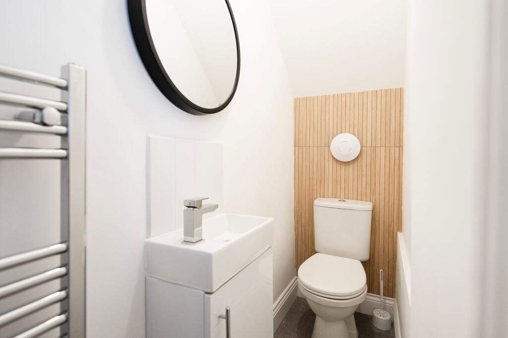 Bright, modern WC with a compact white basin, c...