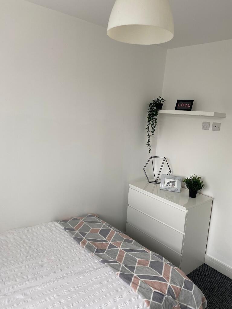 This charming double bedroom features a cozy at...