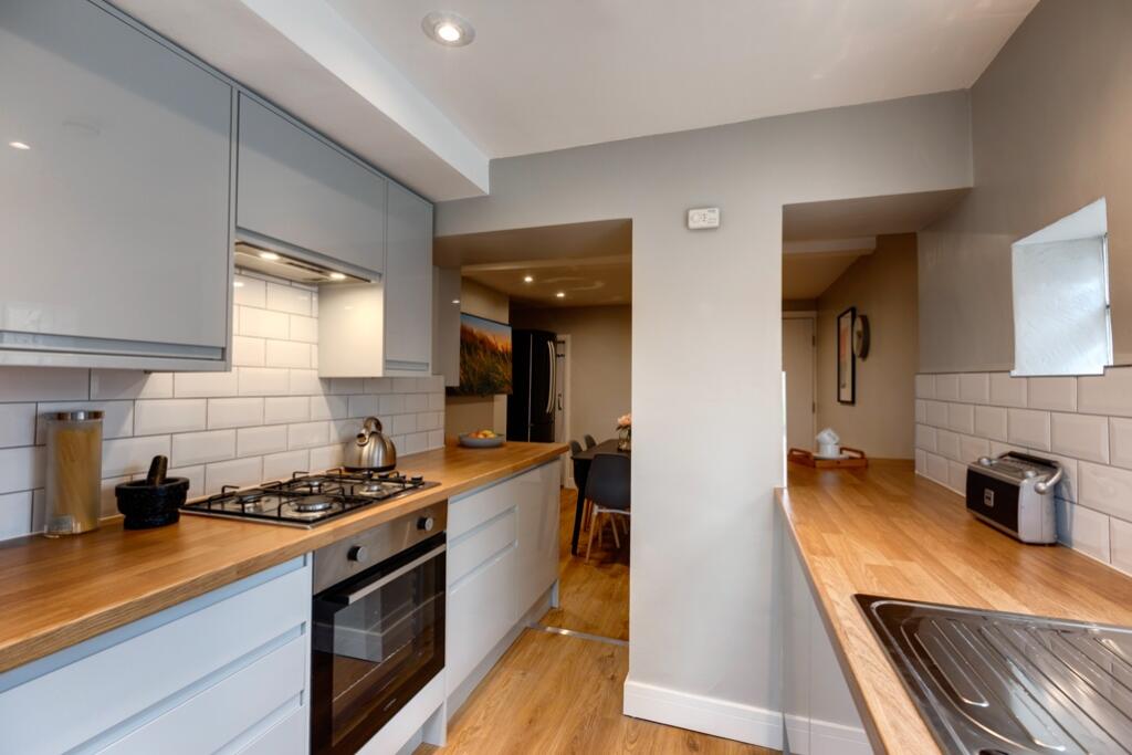 Modern kitchen with sleek grey cabinets, white ...