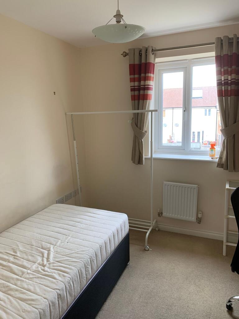 Cozy bedroom with a comfortable single bed, amp...