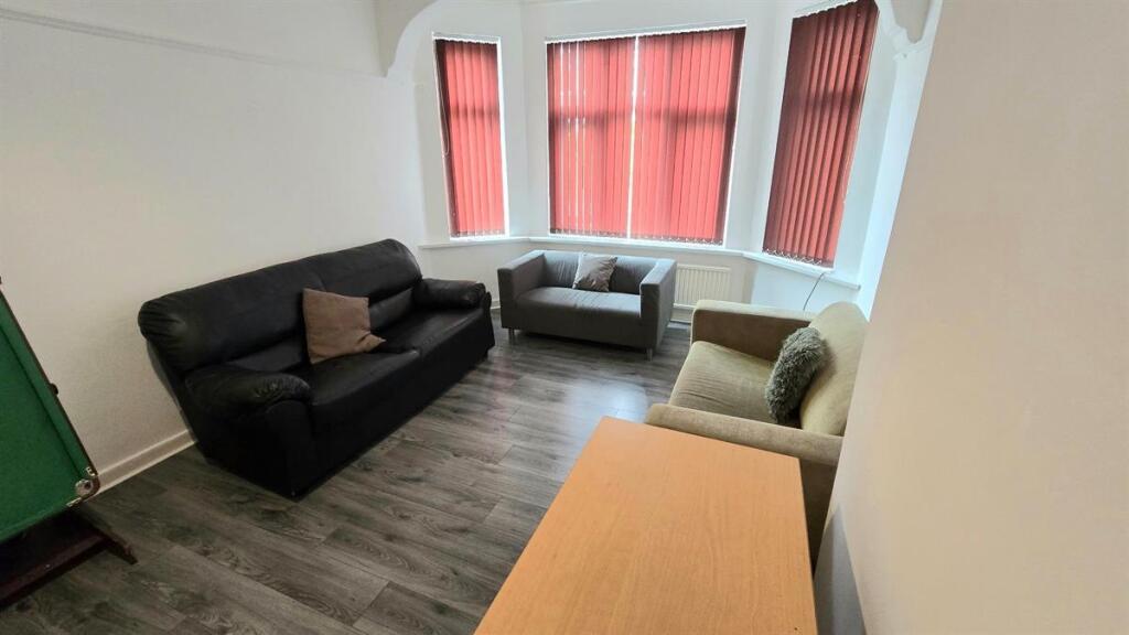 Bright, simply furnished communal lounge with b...