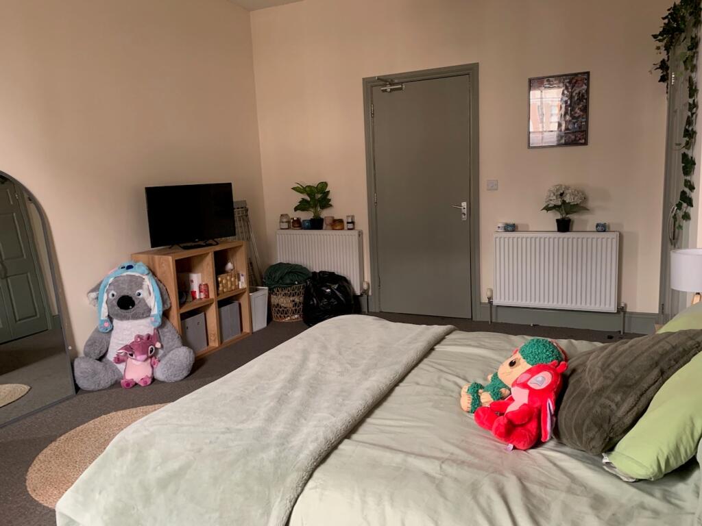 A bright and inviting double bedroom with ample...