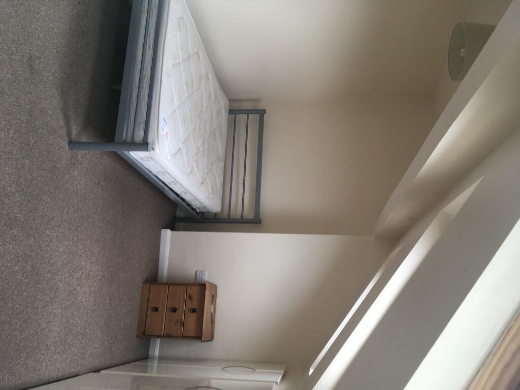 A bright and tidy single bedroom featuring a si...