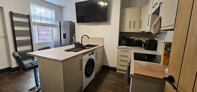 Bright and modern kitchen featuring a central i...