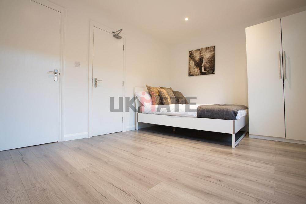 Bright and tidy student room featuring a single...