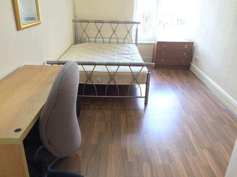 A neat and bright single bedroom featuring wood...