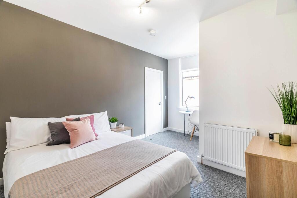 A bright and inviting double bedroom featuring ...