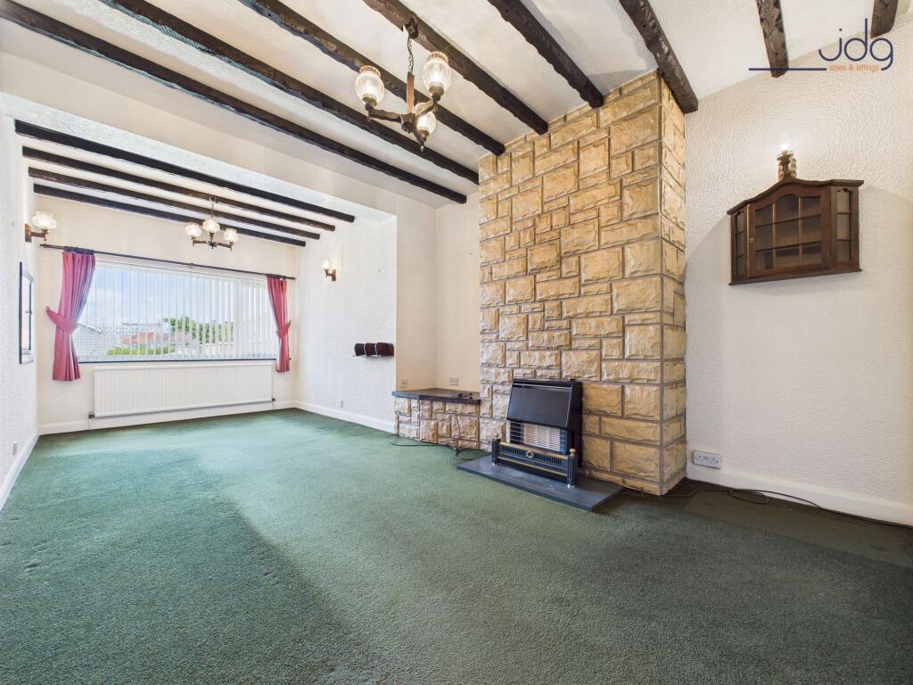 Second sitting room with a stone-clad chimney breast