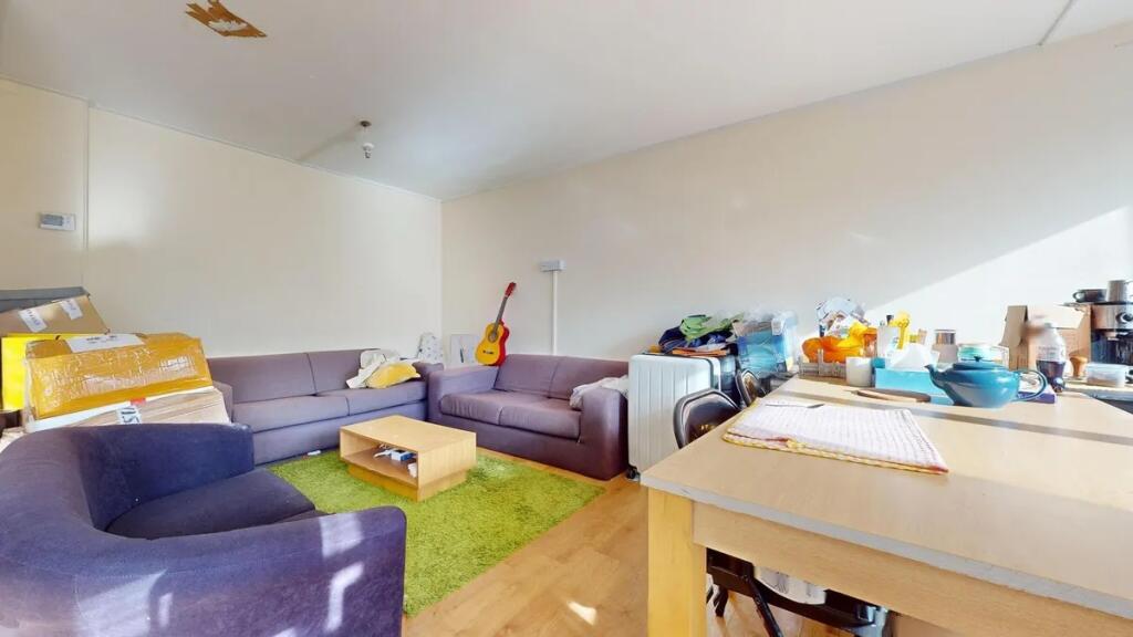 A bright living room featuring ample natural li...
