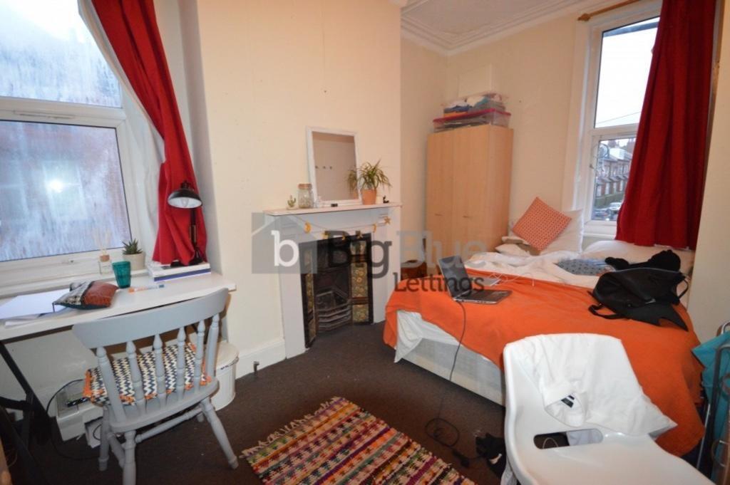Cozy single bedroom featuring a comfortable bed...
