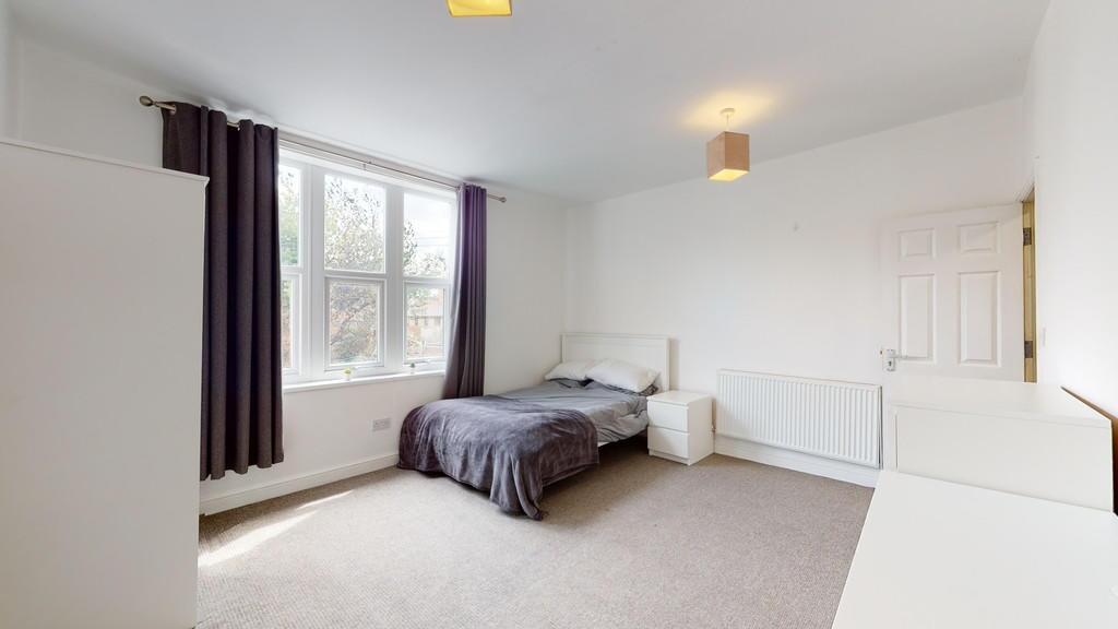 Bright and neatly arranged double bedroom featu...
