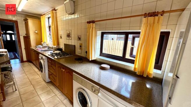 Bright and practical kitchen with ample natural...