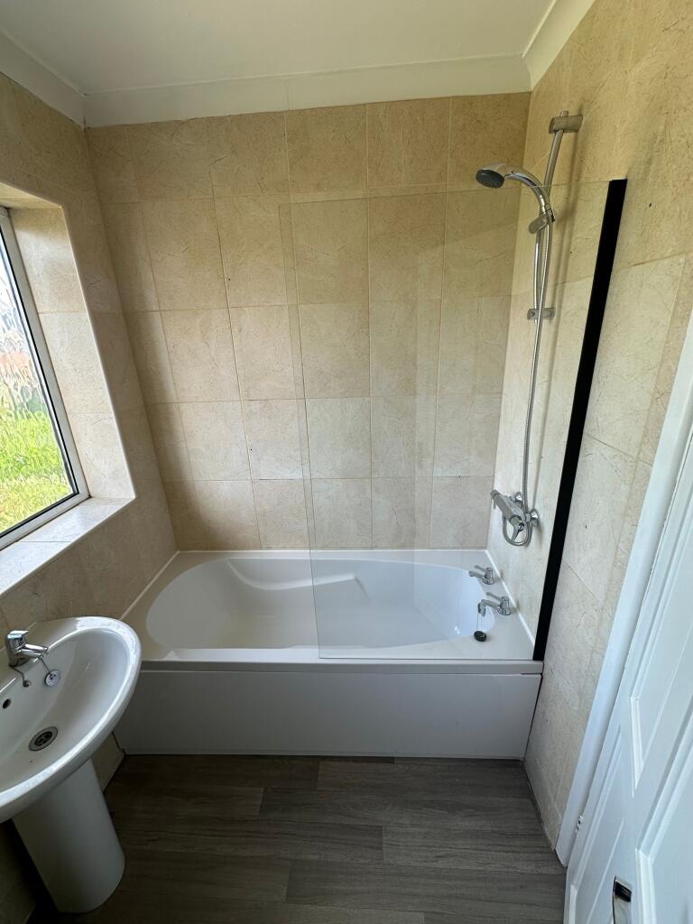 Bright and clean bathroom featuring a modern ba...