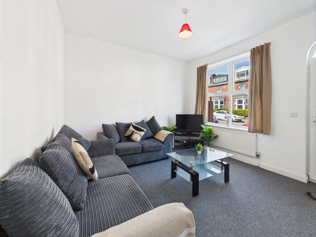 A bright and spacious living room featuring lar...