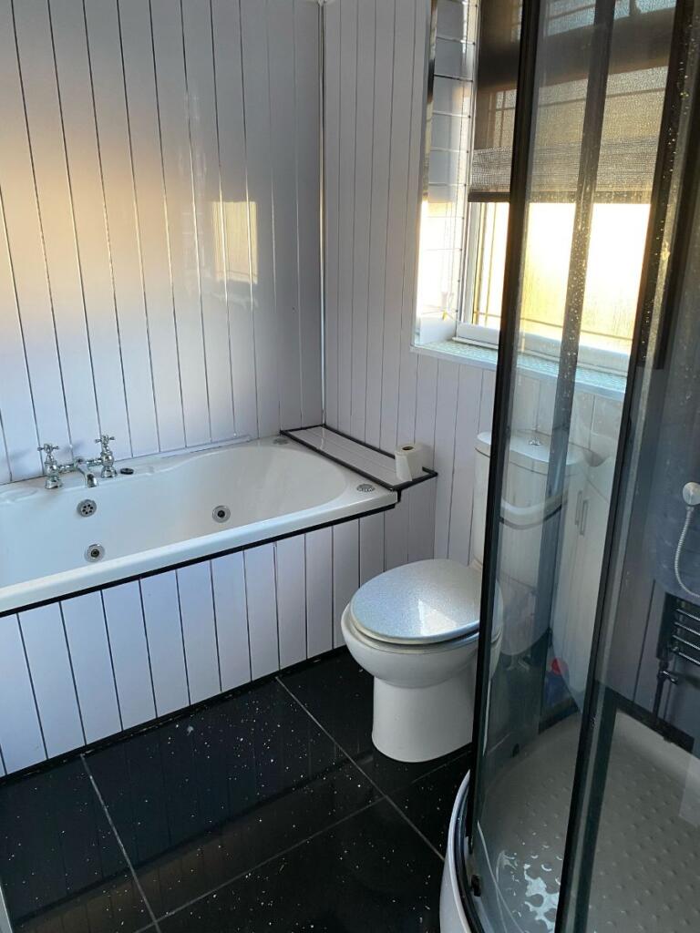 Family bathroom with freestanding shower cubicle 