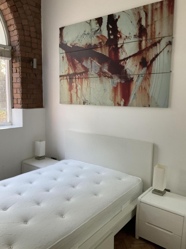 A bright and clean double bedroom featuring a w...
