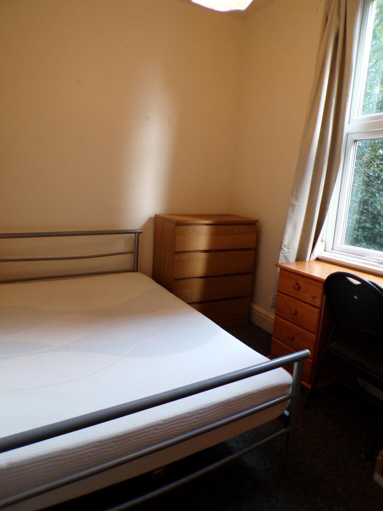 A bright and inviting double bedroom featuring ...