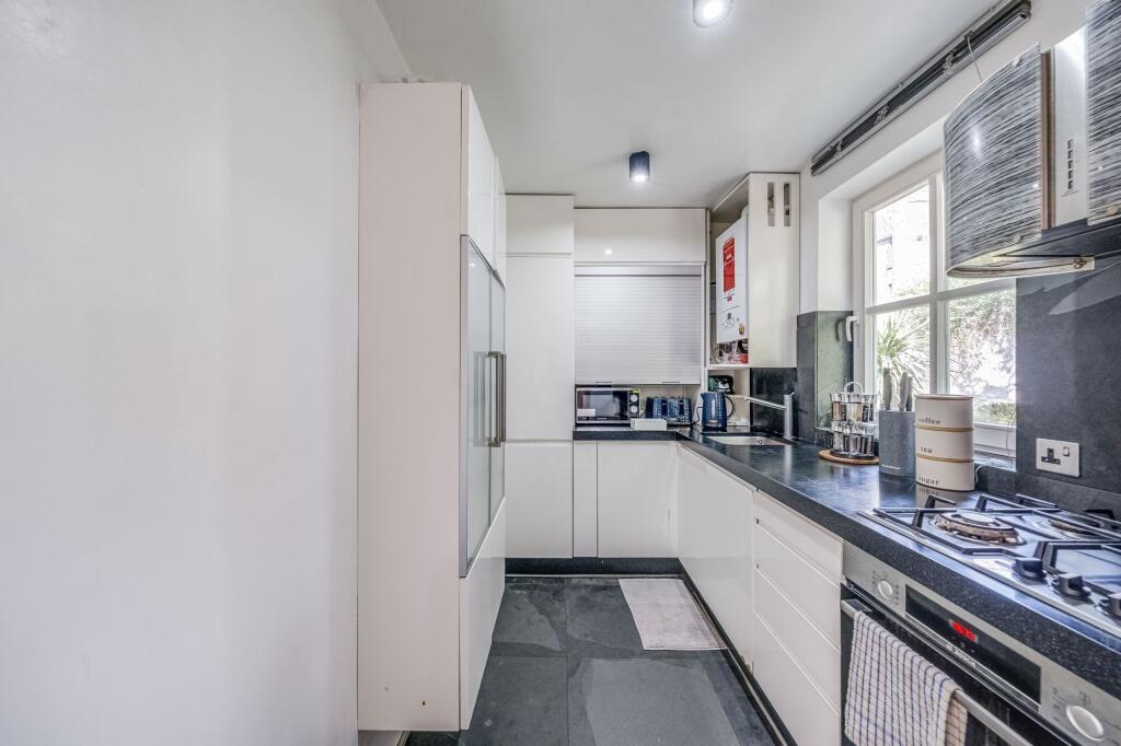 Bright and modern kitchen with sleek white cabi...