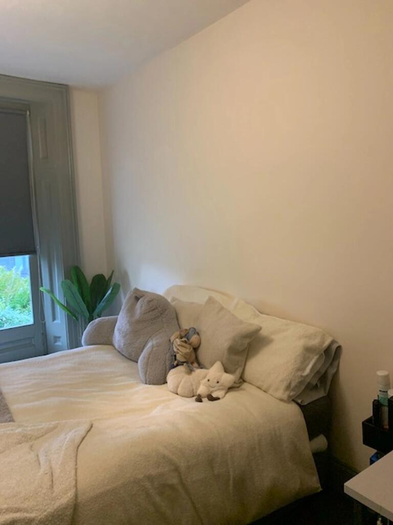 A cozy and inviting double bedroom with soft li...