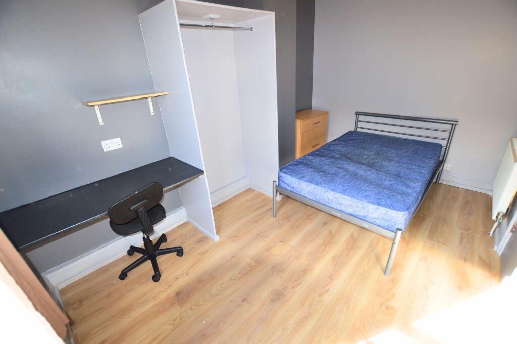 Bright and tidy double bedroom featuring a comf...