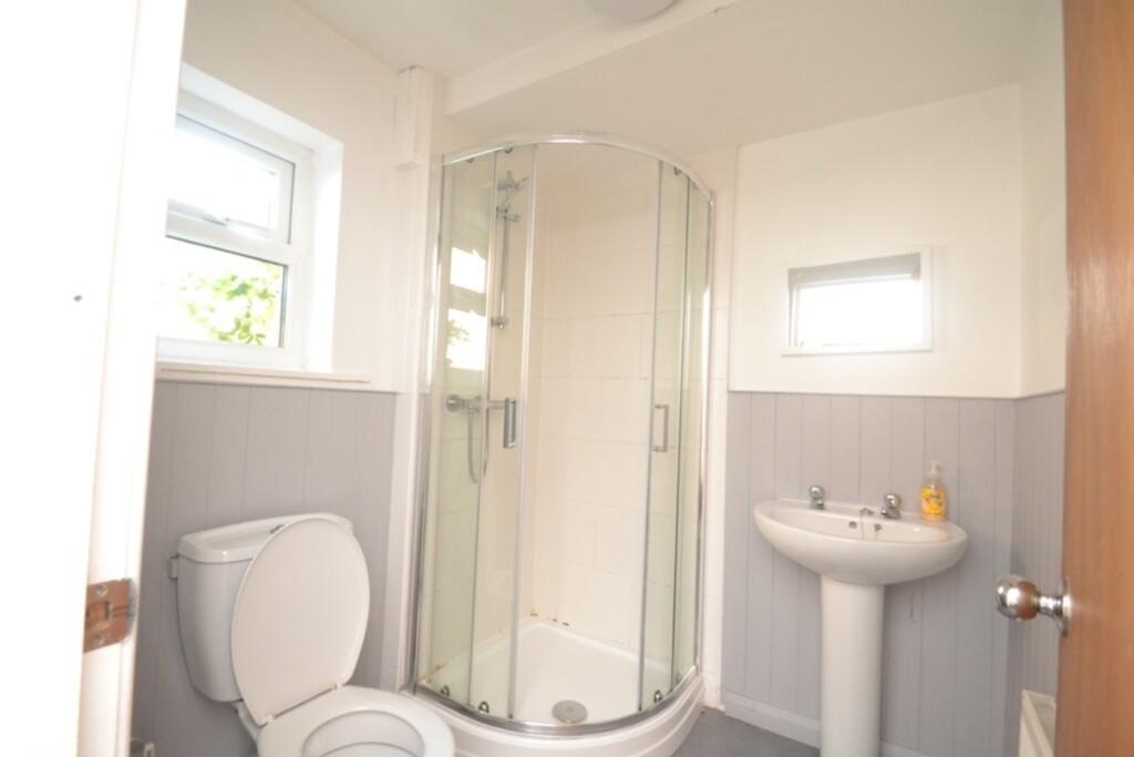 This modern bathroom features a sleek shower en...