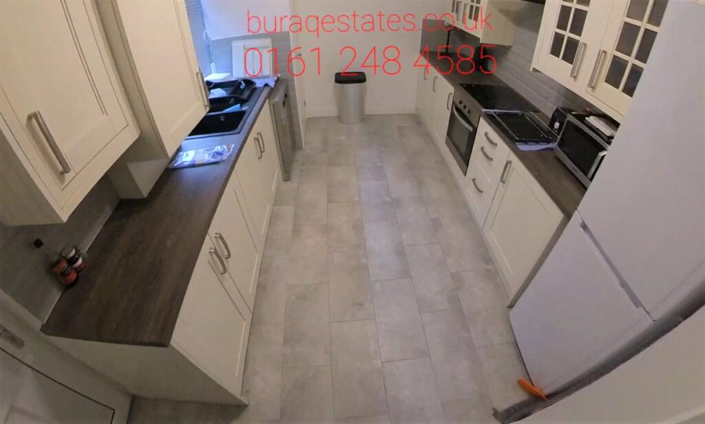 Bright, modern galley kitchen with light floori...