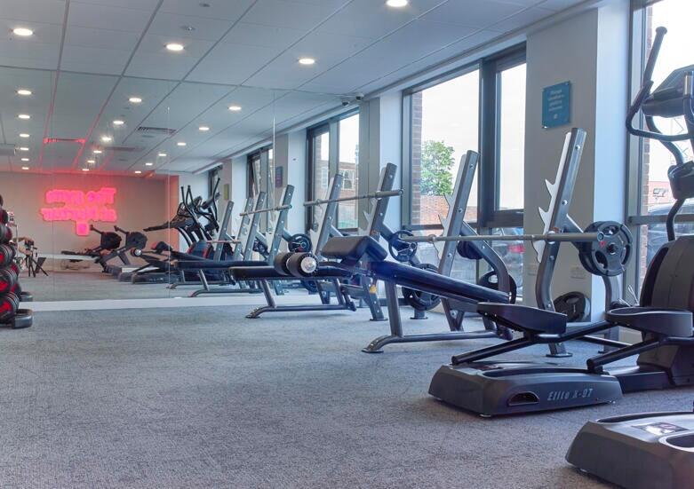 A spacious and well-equipped gym with large win...