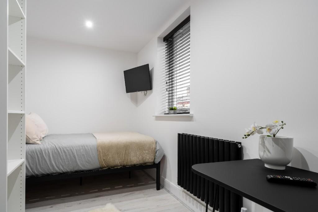 A modern double bedroom featuring clean lines, ...