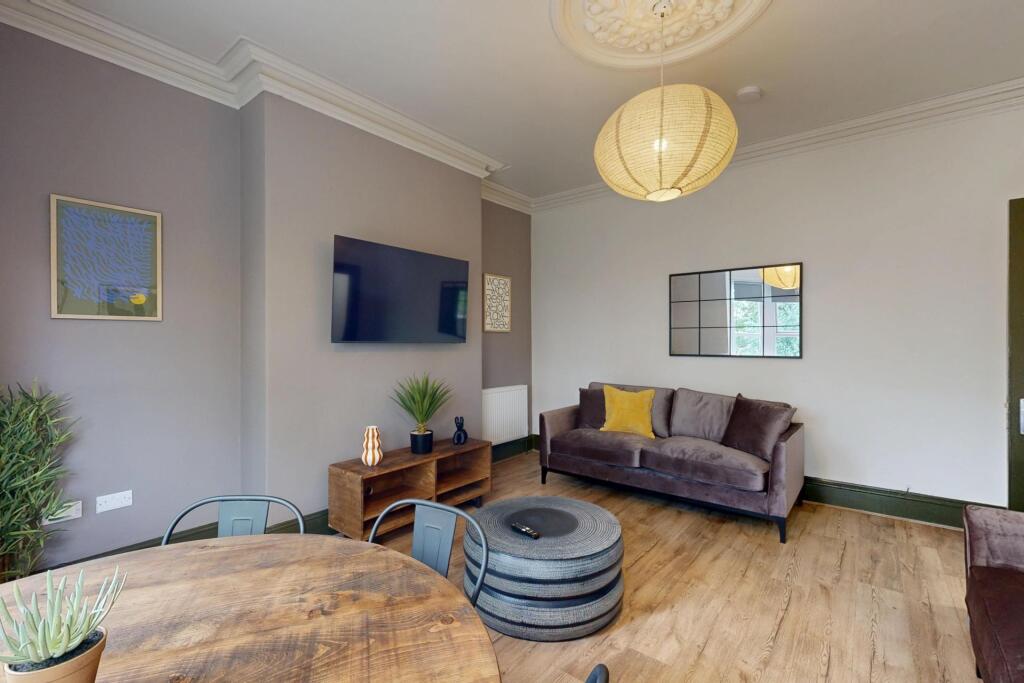 A stylish and well-lit living room featuring co...
