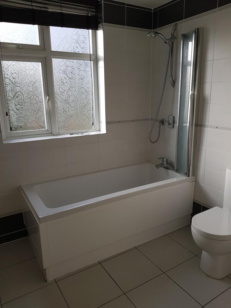 A bright and modern bathroom featuring a clean ...