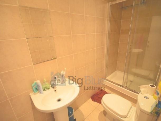 A clean and functional bathroom featuring tiled...